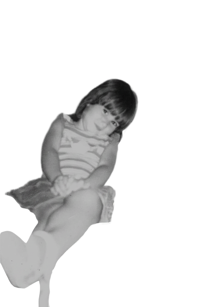 Laura as a child, sitting on the sofa